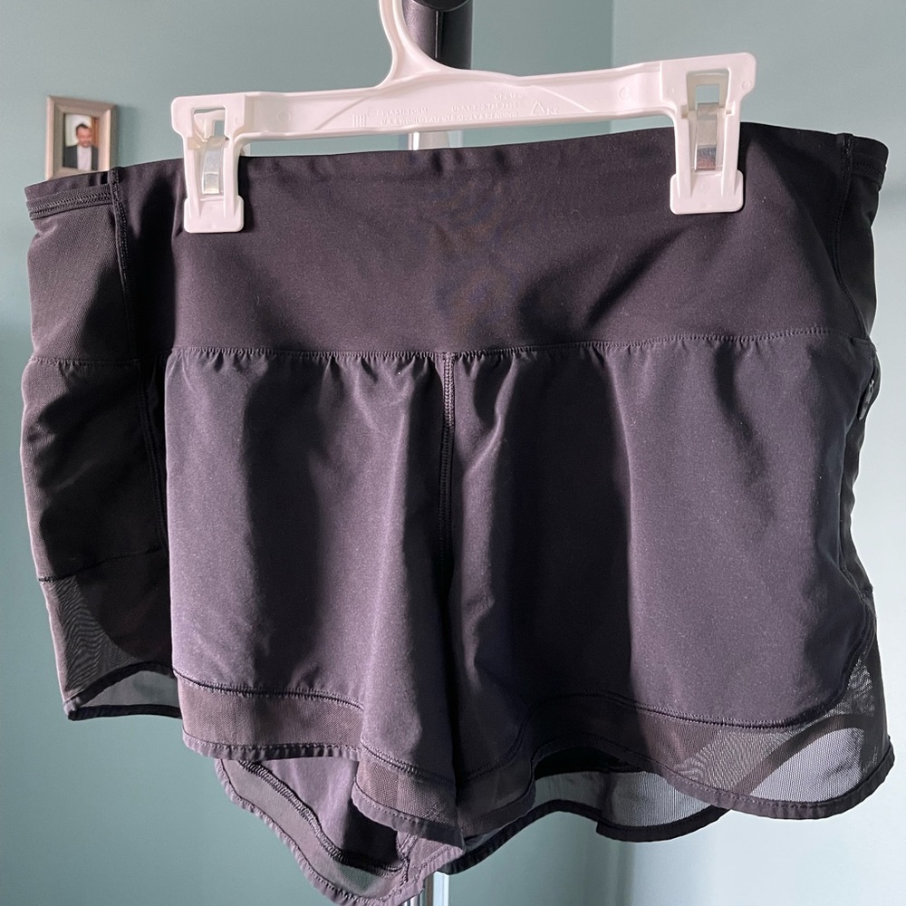 Lululemon black running shorts with mesh trim. Excellent condition.